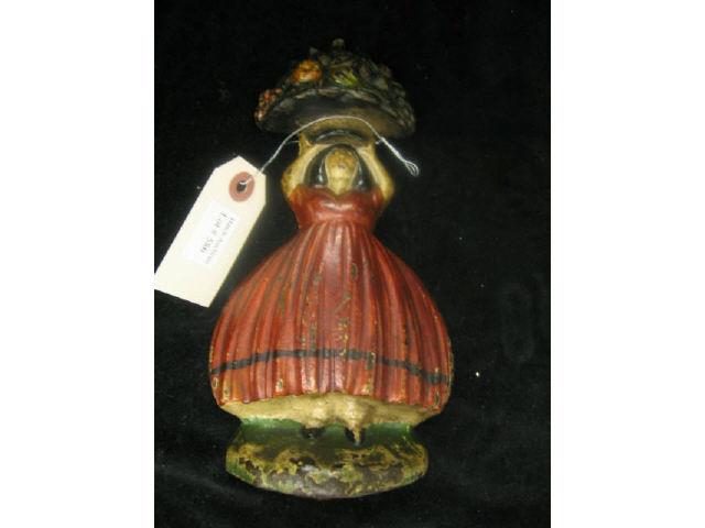 Appraisal: Cast Iron Figural Doorstop girl with basket of fruit