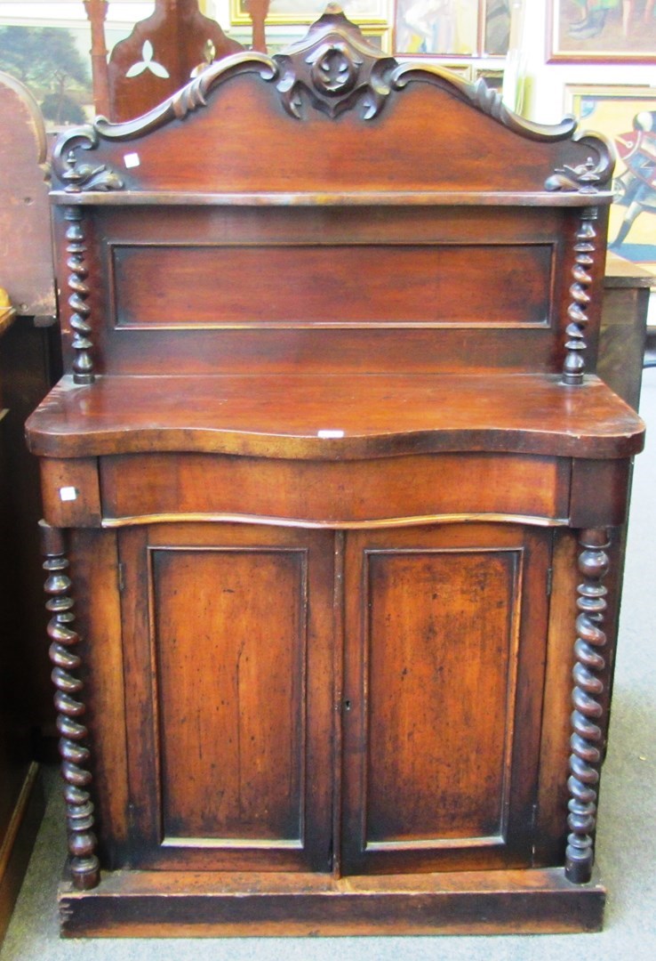 Appraisal: A Victorian mahogany shelf back serpentine chiffonier with barley-twist decoration