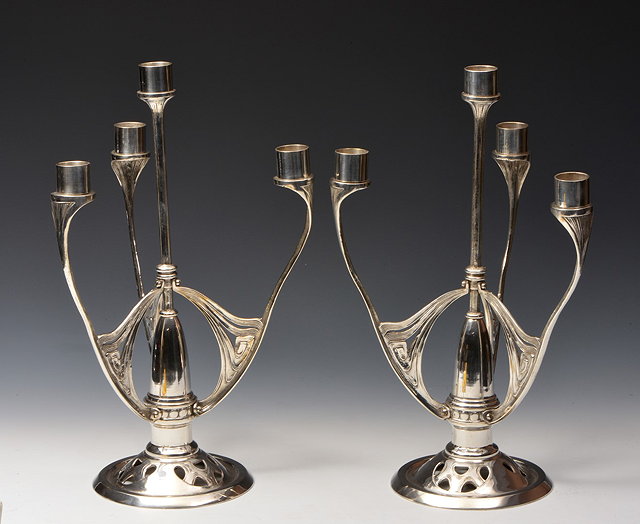 Appraisal: A pair of Austrian German Jugendstil style silver plated candlesticks