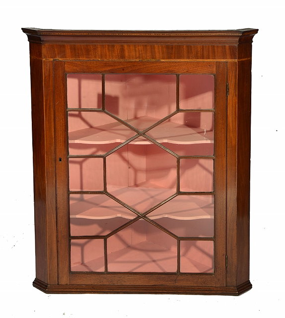 Appraisal: A GEORGE III MAHOGANY HANGING CORNER CABINET with moulded cornice