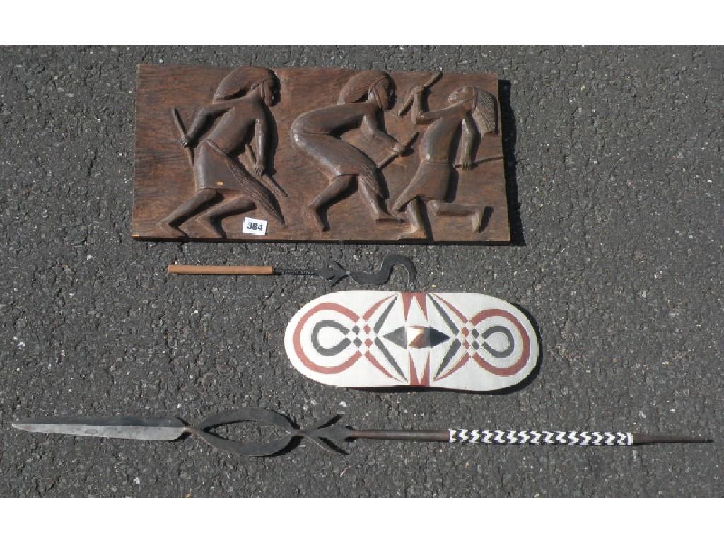 Appraisal: A carved African panel depicting warriors a painted shield and