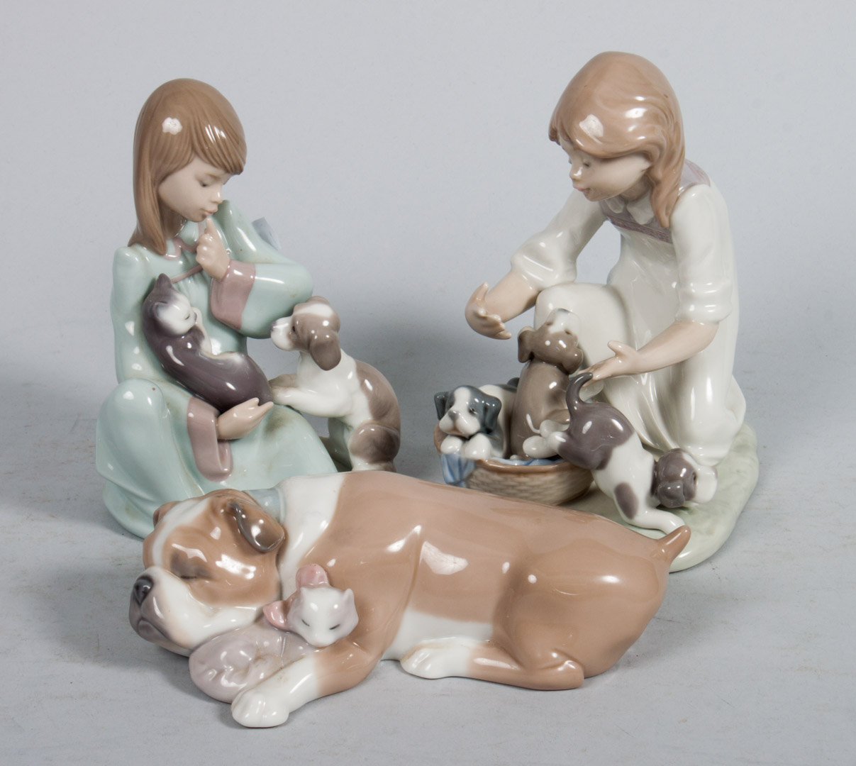 Appraisal: Three Lladro porcelain figural groups Cat Nap in H Unlikely