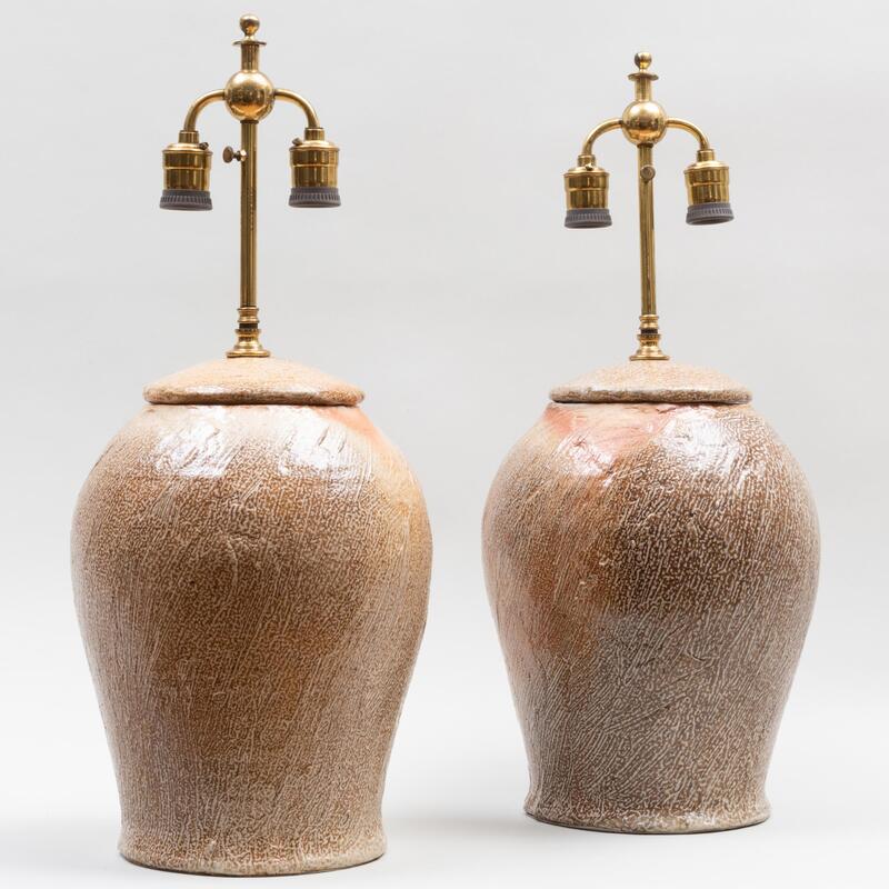 Appraisal: Near Pair of Salt Glazed Earthenware Jars and Covers Mounted