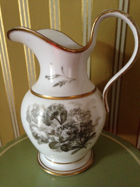 Appraisal: A thC Derby style jug decorated in black with flowers