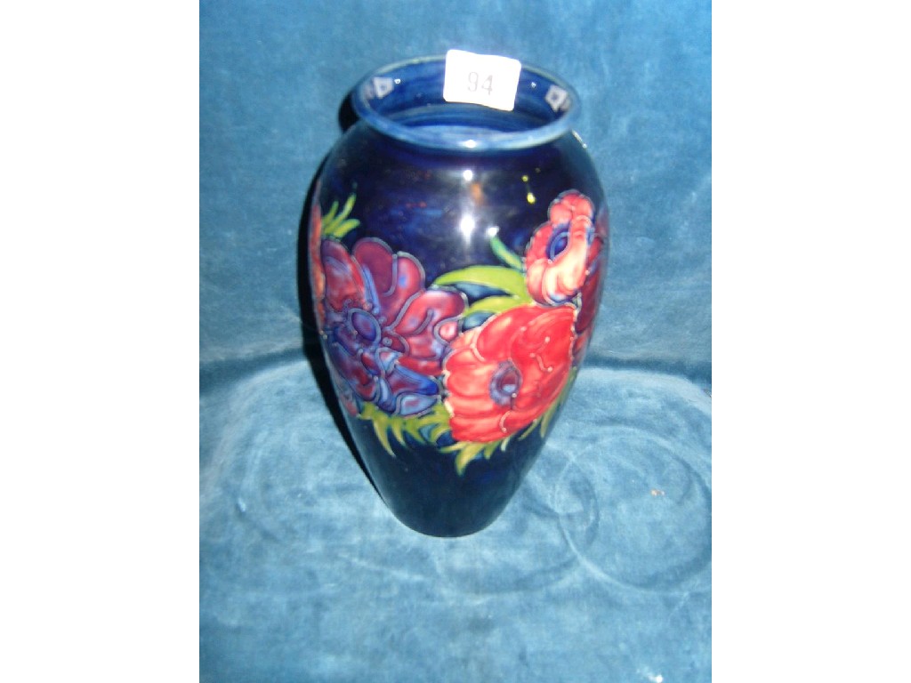 Appraisal: A Moorcroft blue ground vase with red and purple anemone