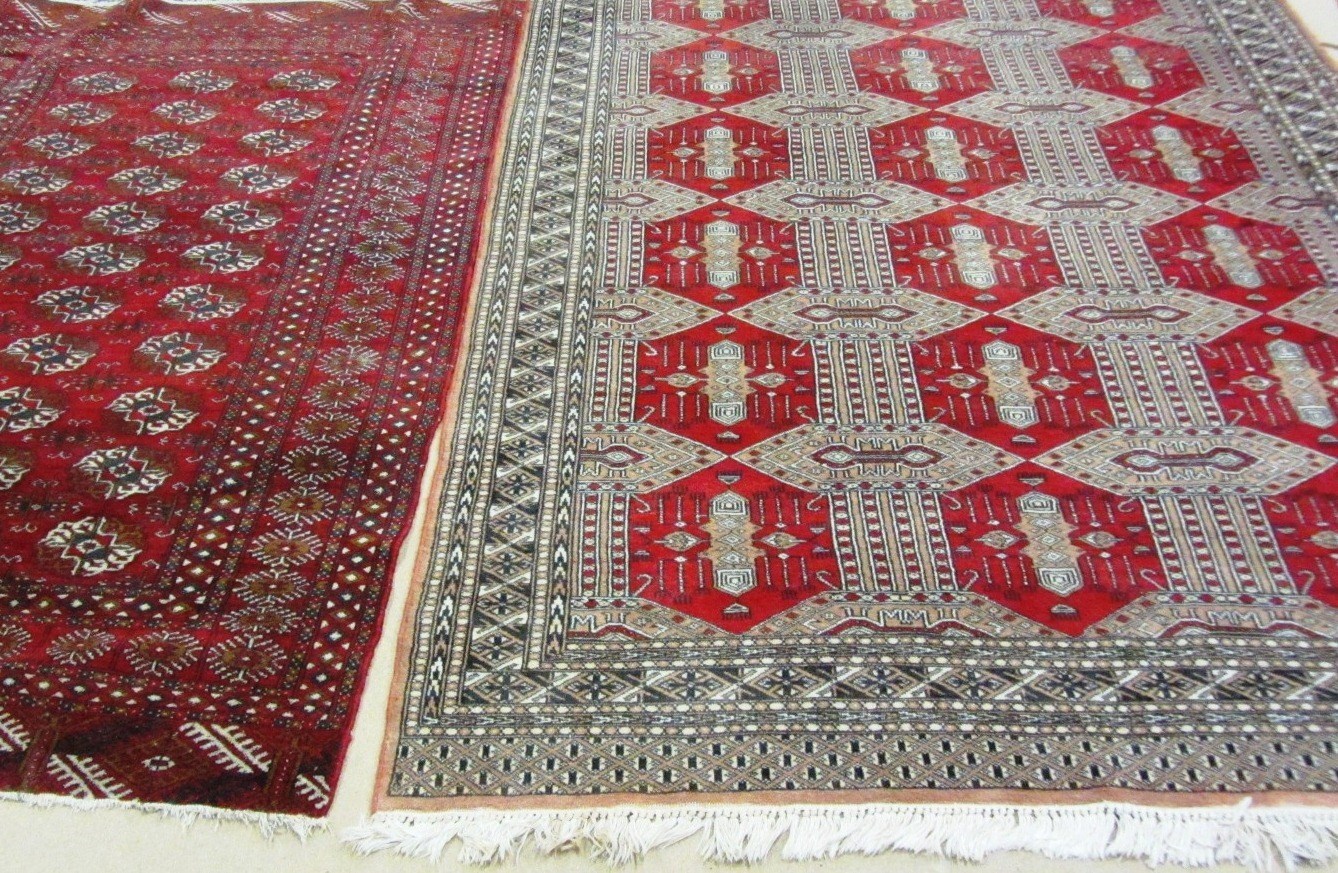 Appraisal: A Pakistan Bokhara carpet the madder sectioned field with stylized