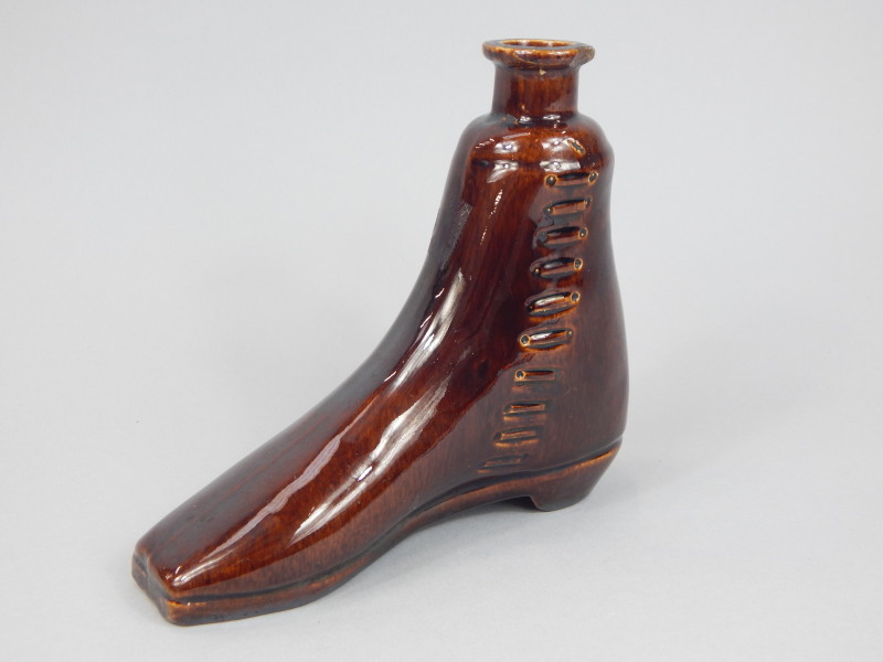 Appraisal: A thC treacle glazed stoneware whiskey flask or boot warmer