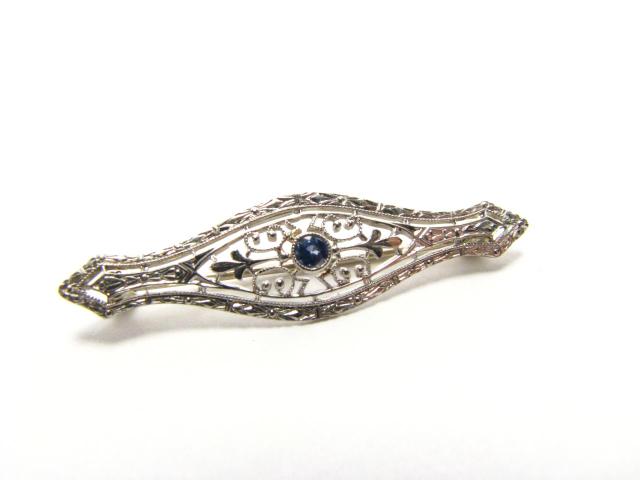 Appraisal: K white gold filigree pin with round pave mounted tanzanite