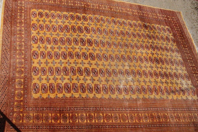 Appraisal: A TH CENTURY RUG on tangerine ground with geometric patterns