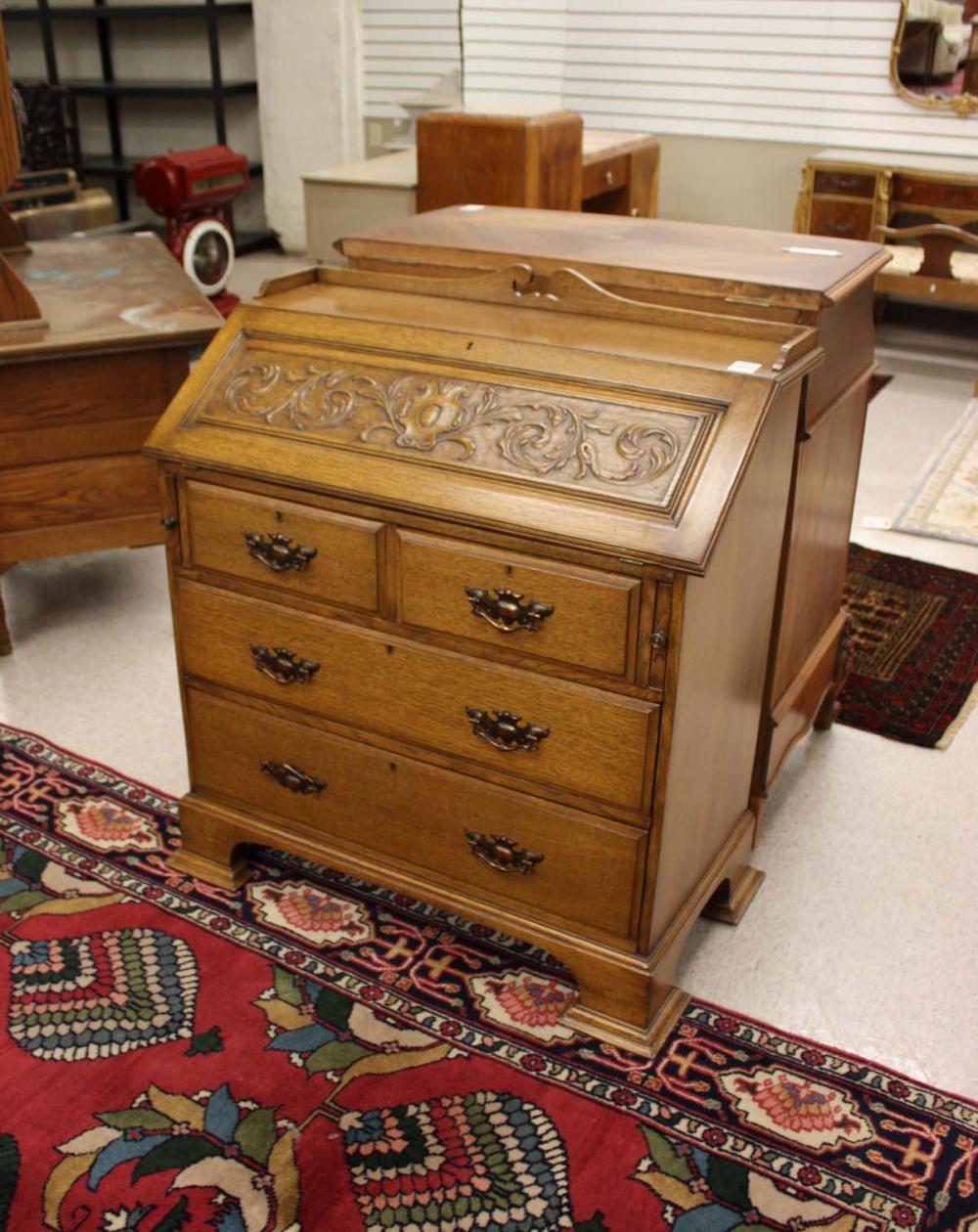 Appraisal: CARVED SLANT-TOP SECRETARY English c the hinged slant top over