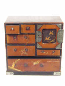 Appraisal: A miniature oriental cabinet in black lacquer decorated in red