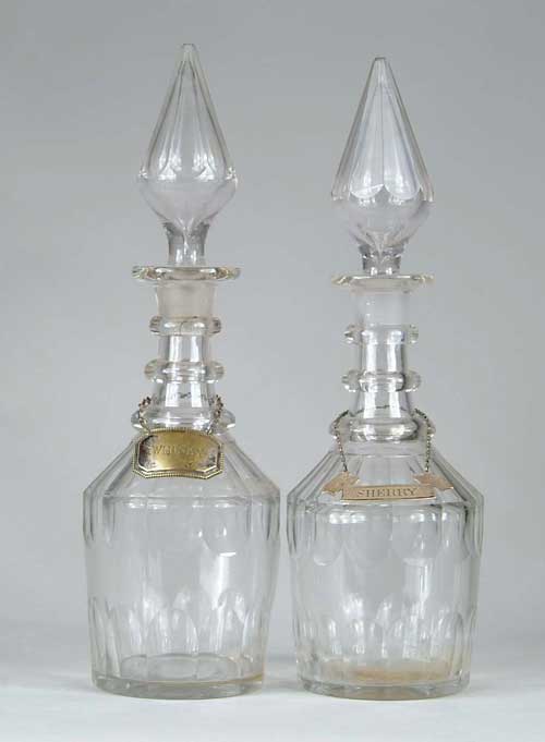 Appraisal: PAIR OF CUT GLASS THREE RING DECANTERS Bevel cutting on