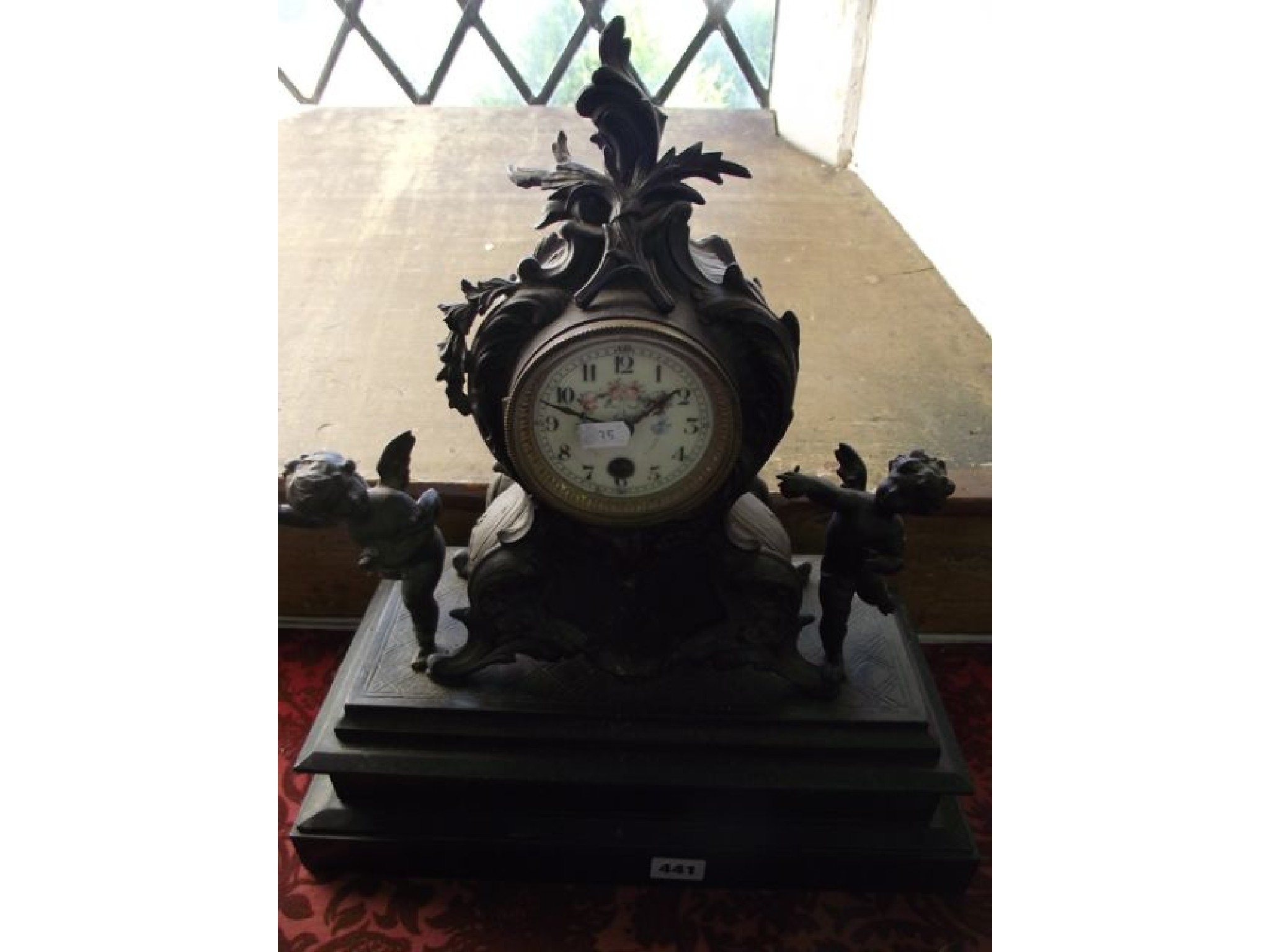 Appraisal: A Victorian cast iron and black slate mantel clock with