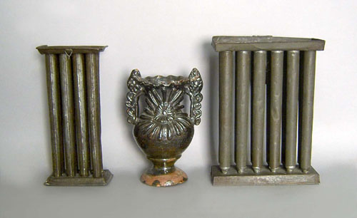 Appraisal: Two tin candlemolds th c together with a pottery vase