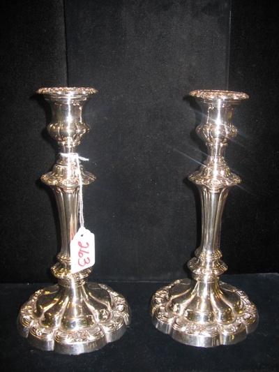 Appraisal: PAIR OF ORNATE ENGLISH SILVERPLATED CANDLESTICKS with removable wax catchers