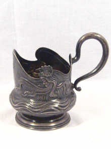 Appraisal: A Russian Art Nouveau silver tea glass holder depicting a