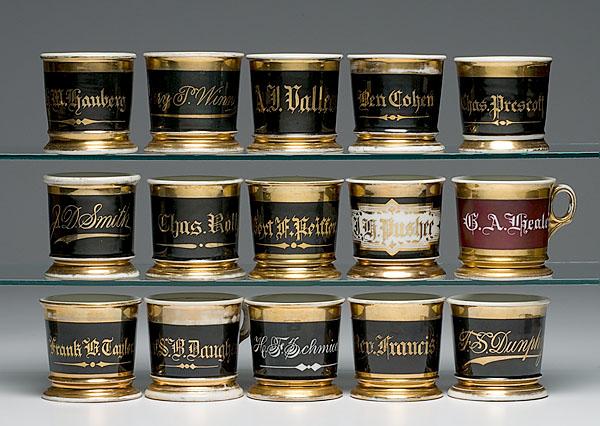 Appraisal: FIFTEEN SHAVING MUGS WITH MONOCHROME WRAPS AND GILT NAMES fourteen