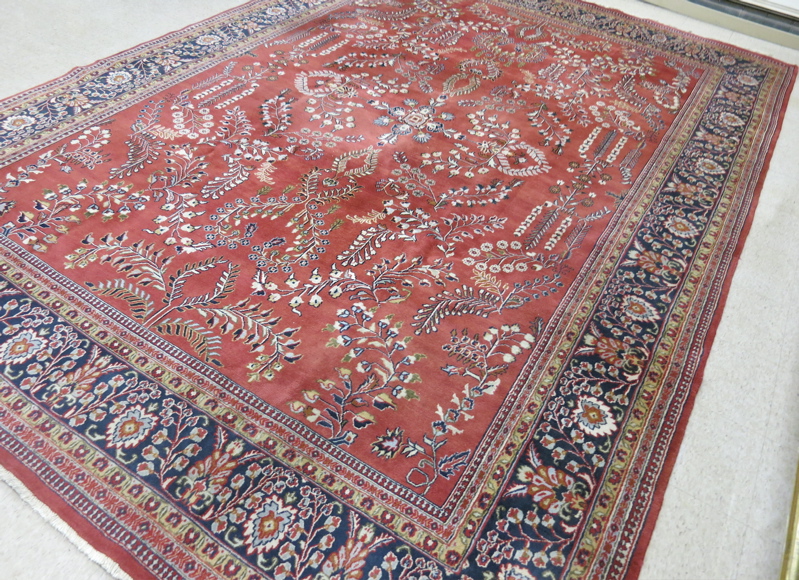 Appraisal: HAND KNOTTED ORIENTAL CARPET a red field Indo-Sarouk with floral