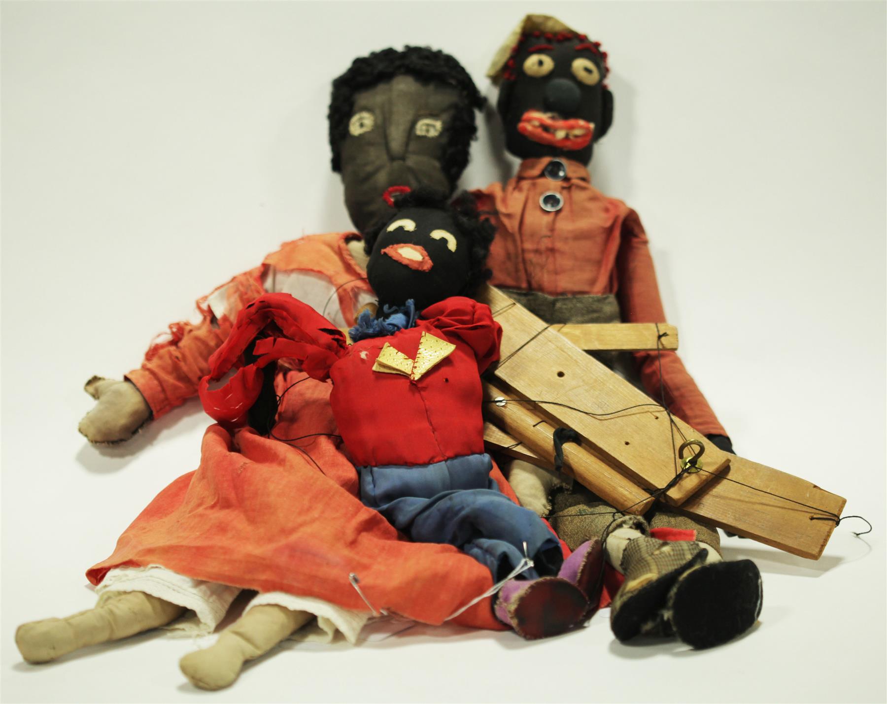 Appraisal: THREE VERY FOLKSY BLACK CLOTH DOLLS Late th-early th century