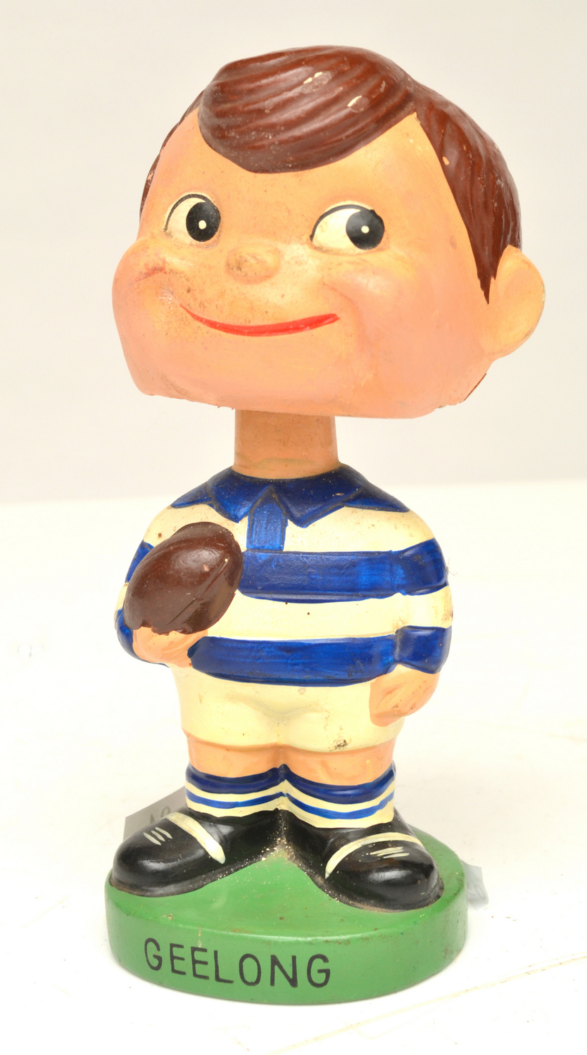 Appraisal: A VINTAGE PAINTED PAPIER MACHE GEELONG FOOTBALL CLUB 'NODDER' FIGURINE