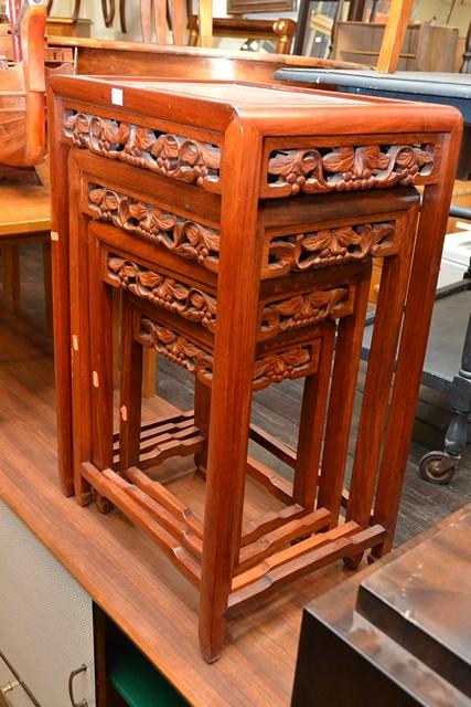 Appraisal: AN ORIENTAL HARDWOOD NEST OF FOUR CARVED SIDE TABLES