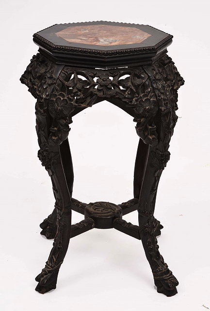 Appraisal: A CHINESE CARVED HARDWOOD URN STAND with octagonal top and