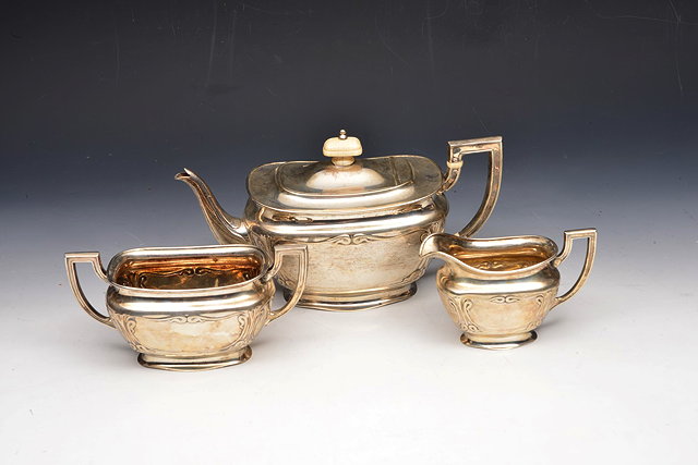 Appraisal: A SILVER THREE PIECE TEA SERVICE of rounded rectangular form