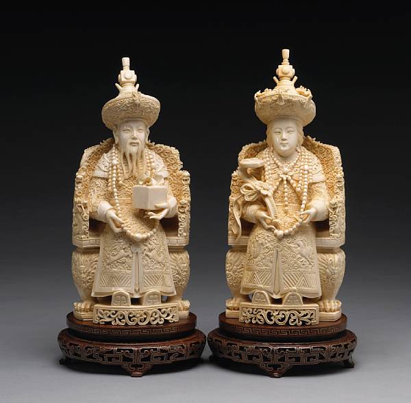 Appraisal: A pair of carved ivory emperor and empress figures th