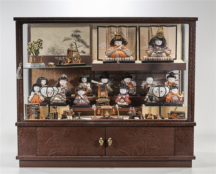 Appraisal: Large display case with numerous Japanese dolls miniature lacquer and