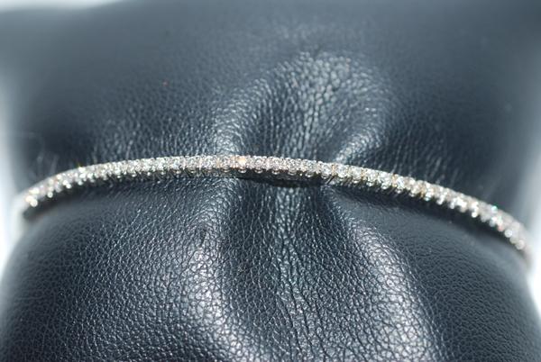 Appraisal: A DIAMOND BANGLE SET WITH ROUND BRILLIANT CUT DIAMONDS TOTALLING