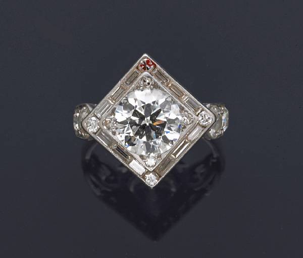 Appraisal: A diamond ring centering a round brilliant-cut diamond principal diamond