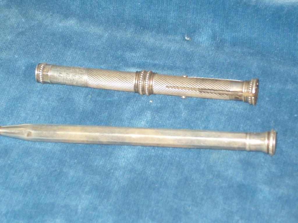 Appraisal: A white metal office pencil with fluted decoration and engraved