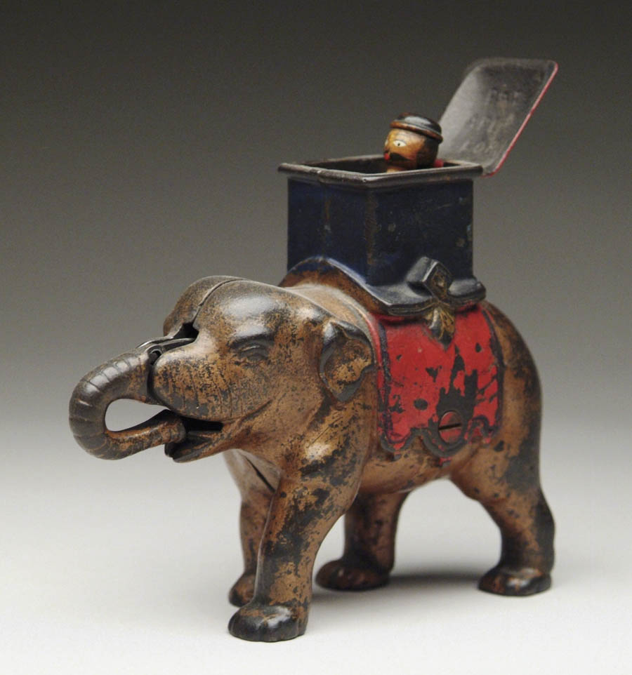 Appraisal: ELEPHANT AND HOWDAH MECHANICAL BANK MAN POPS OUT Place coin