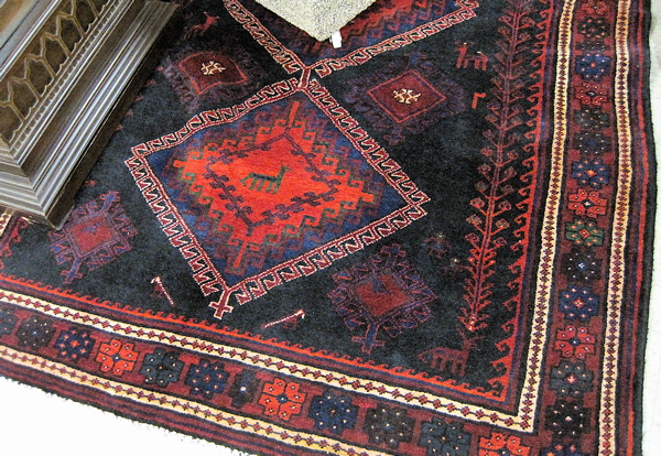 Appraisal: PERSIAN ILATI TRIBAL CARPET the plain black field featuring a