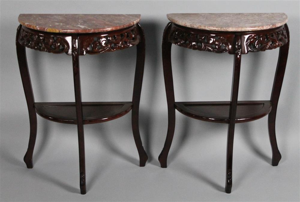 Appraisal: PAIR OF CHINESE CARVED EBONIZED AND MARBLE TOPPED DEMILUNE TABLES