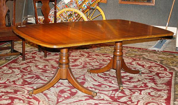 Appraisal: A Regency style mahogany double pedestal dining table with three