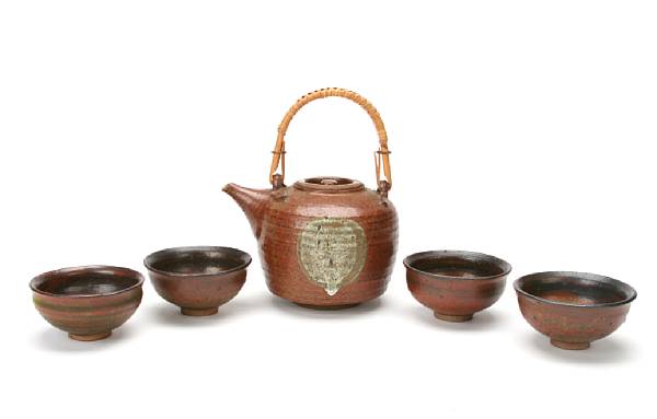 Appraisal: Angelo Garcia Tea Set glazed earthenware wheel thrown wicker and