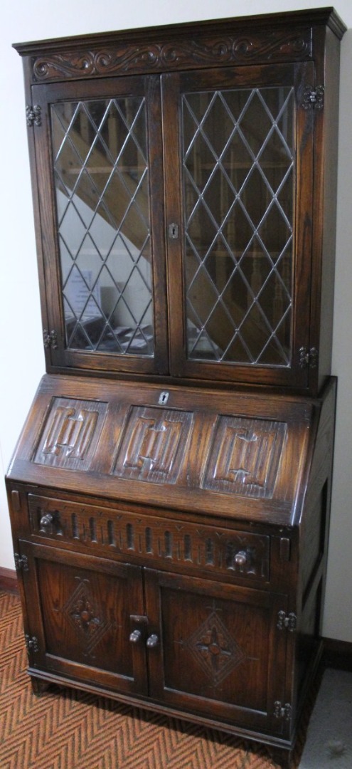 Appraisal: A Jaycee oak linen fold bureau bookcase the upper section