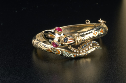 Appraisal: Serpent bracelet in k yg with rubies sapphires diamonds and