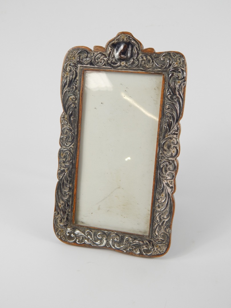 Appraisal: An Edward VII silver strut photograph frame embossed with rococo