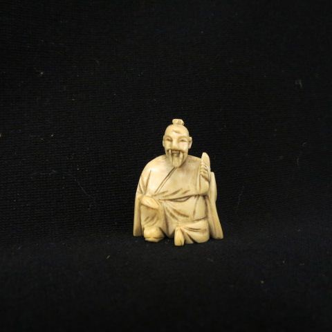 Appraisal: Carved Ivory Netsuke of a Seated Man signed excellent