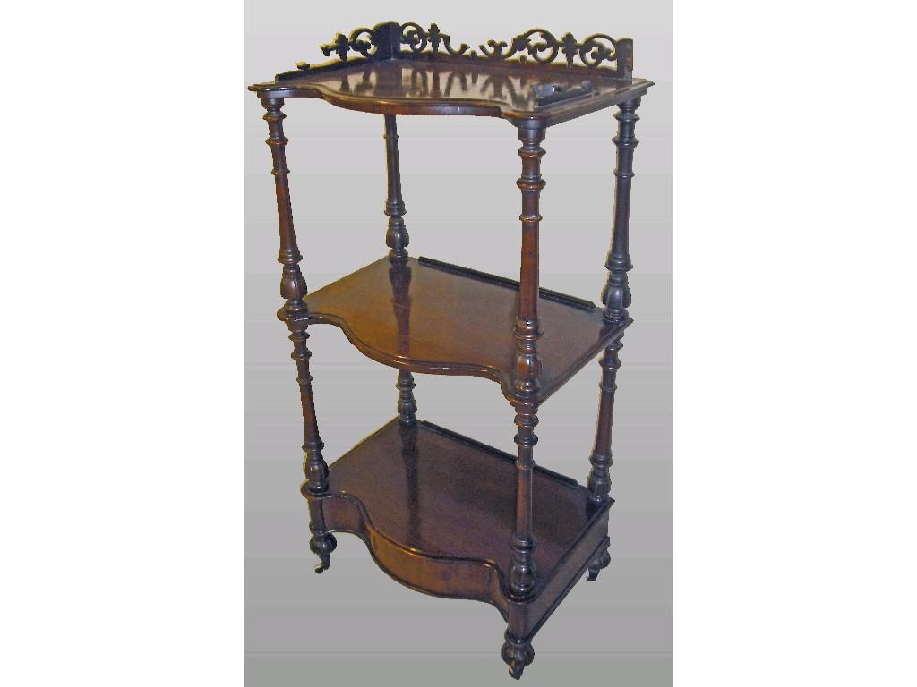 Appraisal: Victorian mahogany serpentine three tier whatnot the raised fretwork gallery