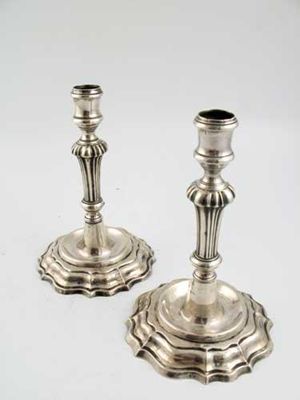 Appraisal: A pair of th century continental candlesticks with fluted knopped