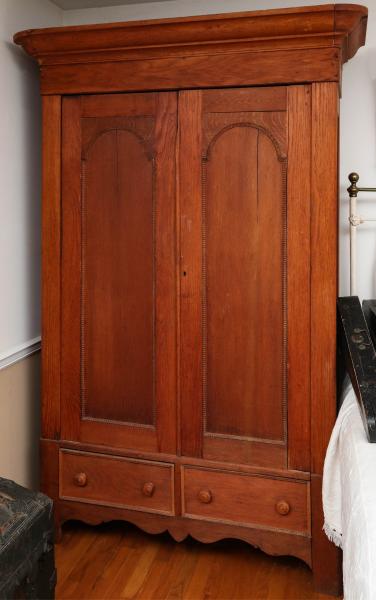 Appraisal: A TALL TH C TWO DOOR WARDROBE WITH DRAWERSThe broad