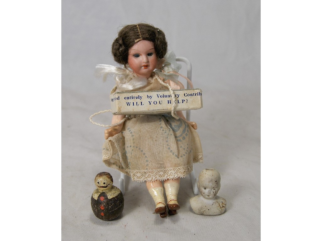 Appraisal: A German small bisque-headed girl doll with brown wig closing