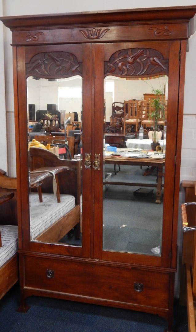 Appraisal: An Art Nouveau mahogany wardrobe the outswept pediment above two