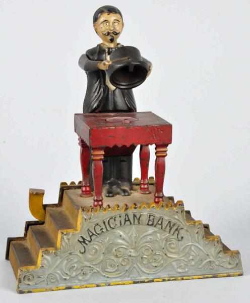 Appraisal: Cast Iron Magician Mechanical Bank Description Manufactured by J E