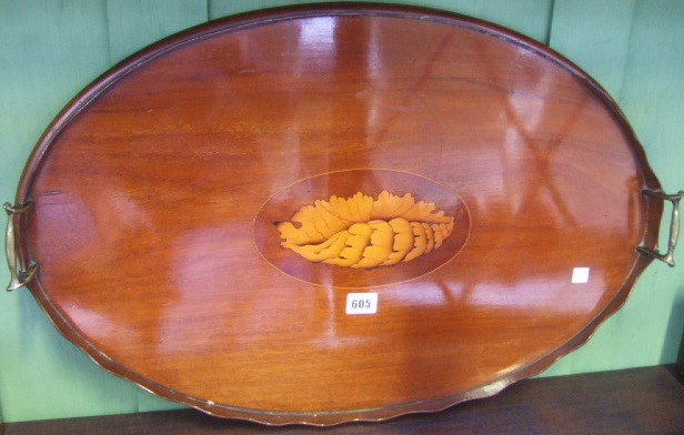 Appraisal: A th century mahogany oval twin handled serving tray with