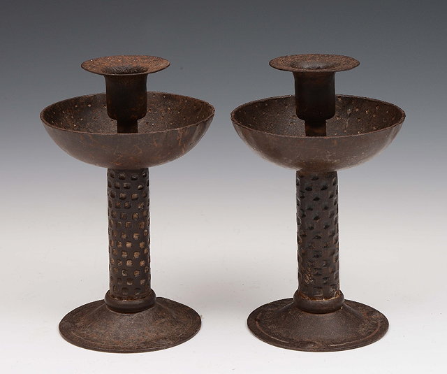 Appraisal: A pair of iron candlesticksin the the Arts Crafts style