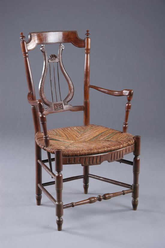 Appraisal: FRENCH PROVINCIAL LYRE-BACK FAUTEUIL th century fruitwood Curving crest rail